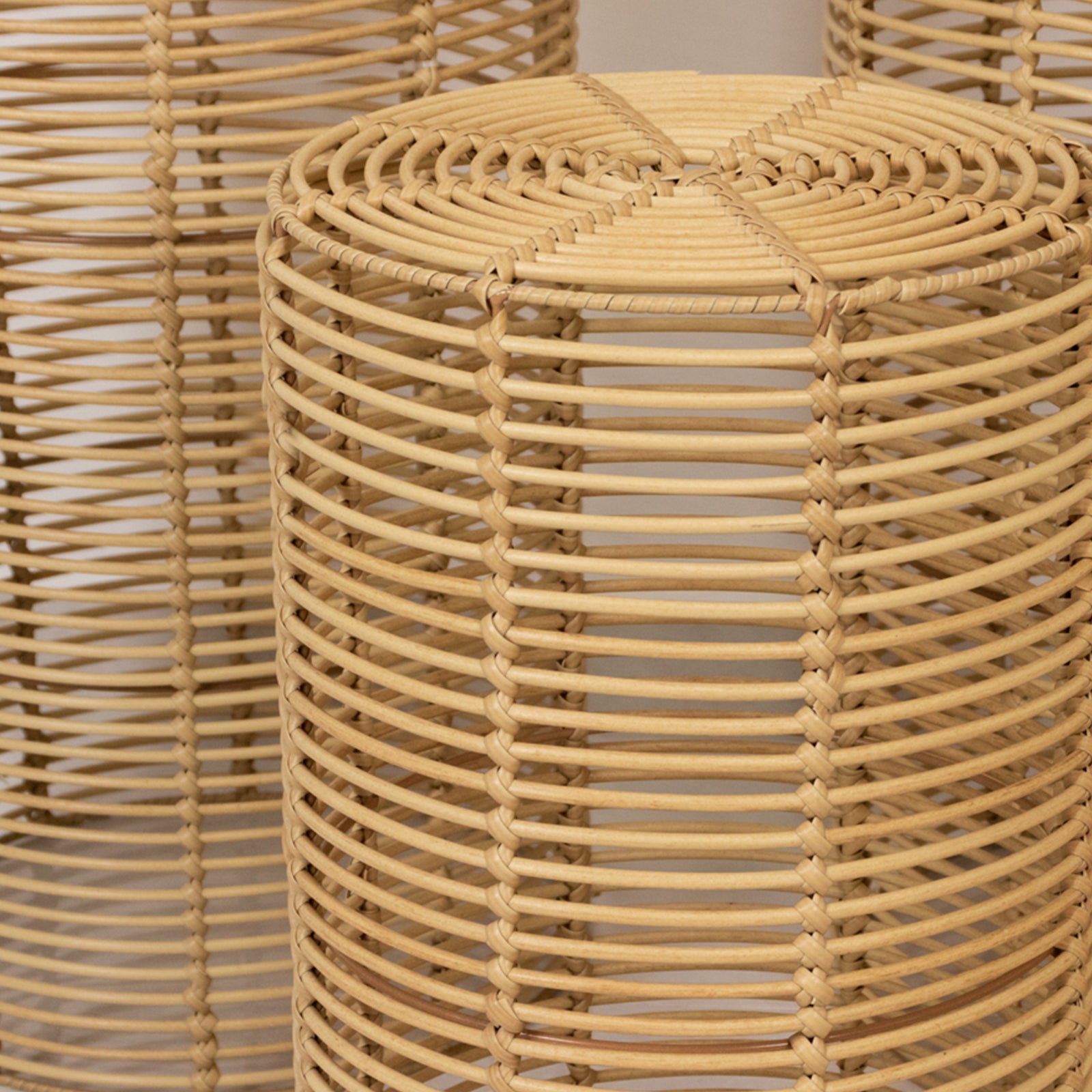 Natural woven rattan pedestal stands in various heights, perfect for boho decor.