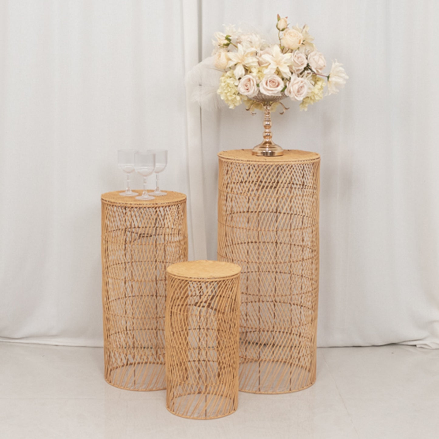 Natural woven rattan wicker pedestal stands with wave pattern in light beige.