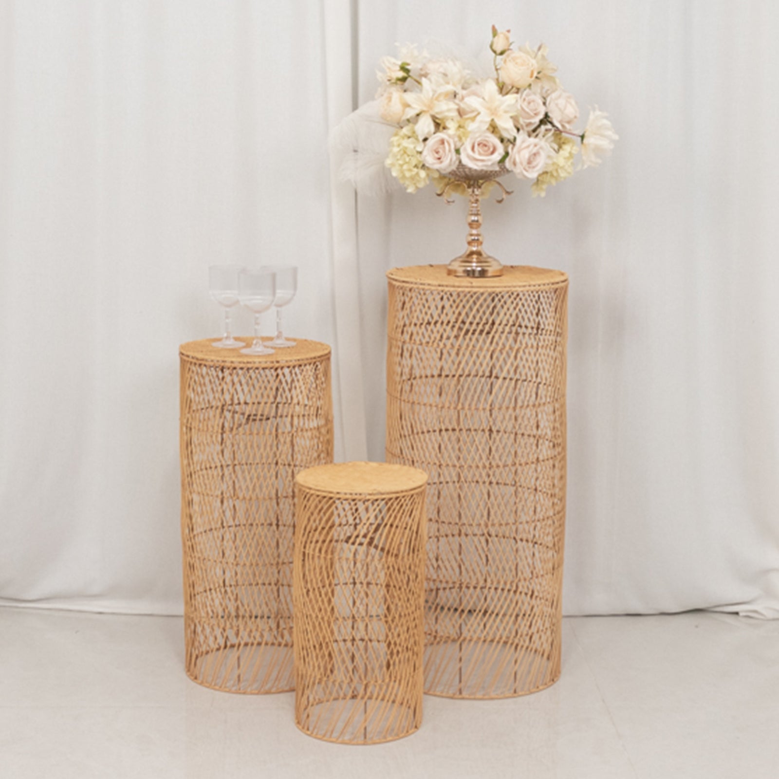 Natural woven rattan wicker pedestal stands with wave pattern in light beige.