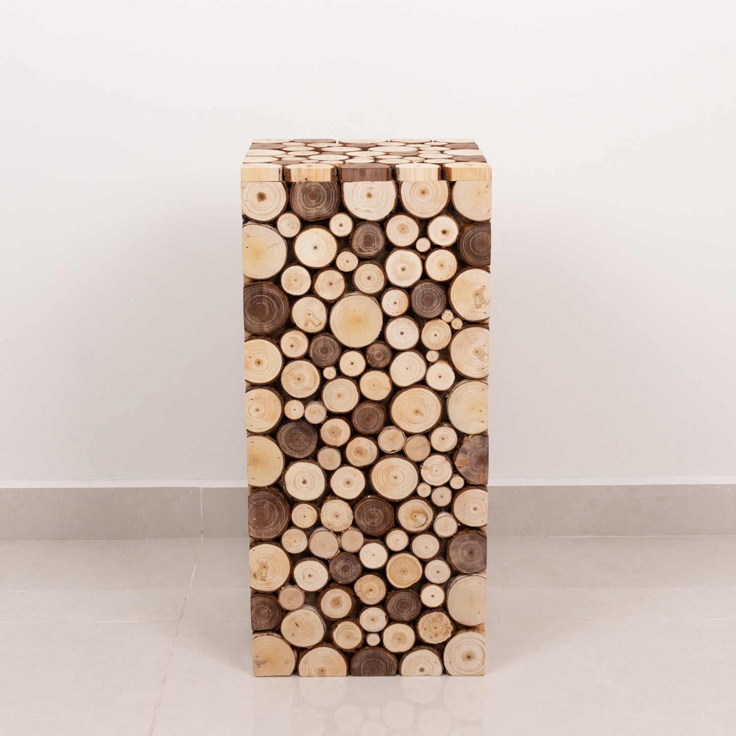 Natural wooden slices pedestal stand in a rustic farmhouse style.