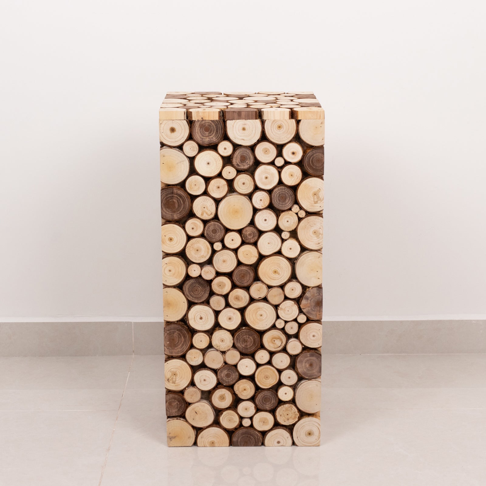 Natural wooden slices pedestal stand in a rustic farmhouse style.