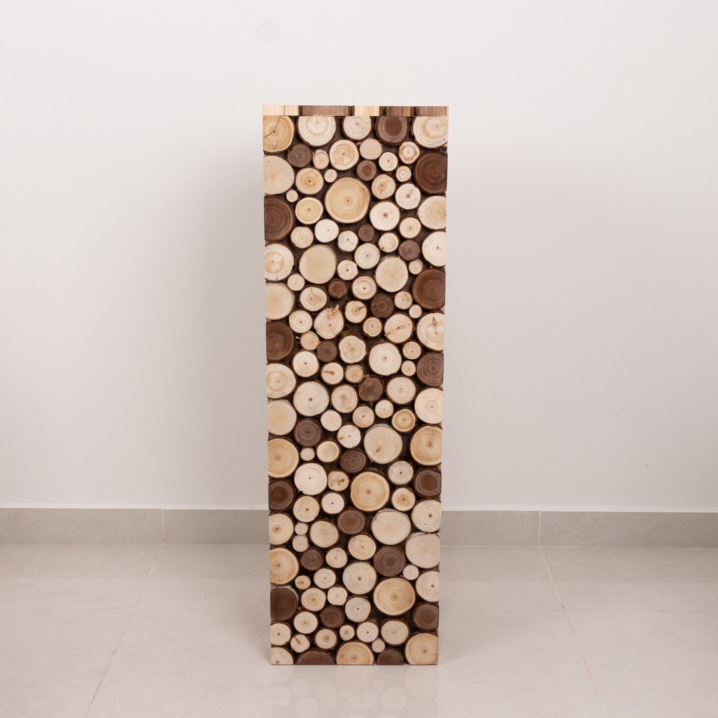 Natural wooden slices pedestal stand for rustic farmhouse decor.