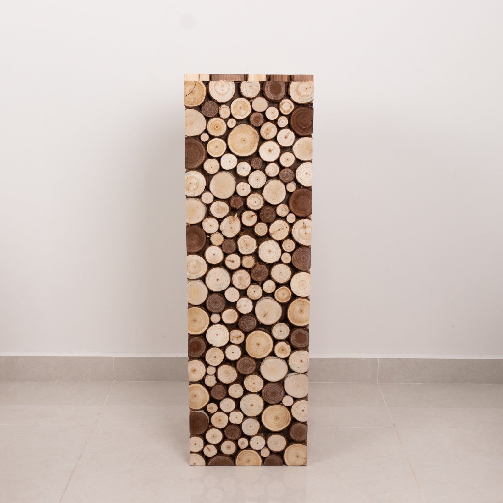 Natural wooden slices pedestal stand for rustic farmhouse decor.