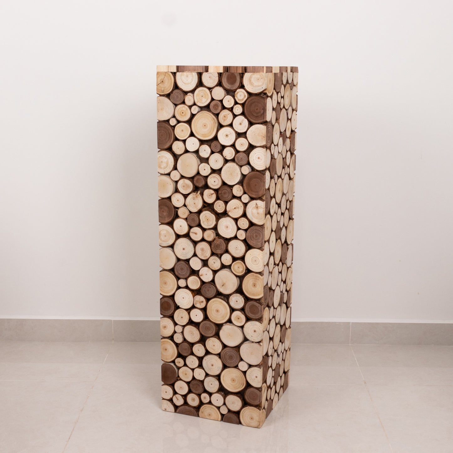 Natural wooden slices pedestal stand for rustic decor.