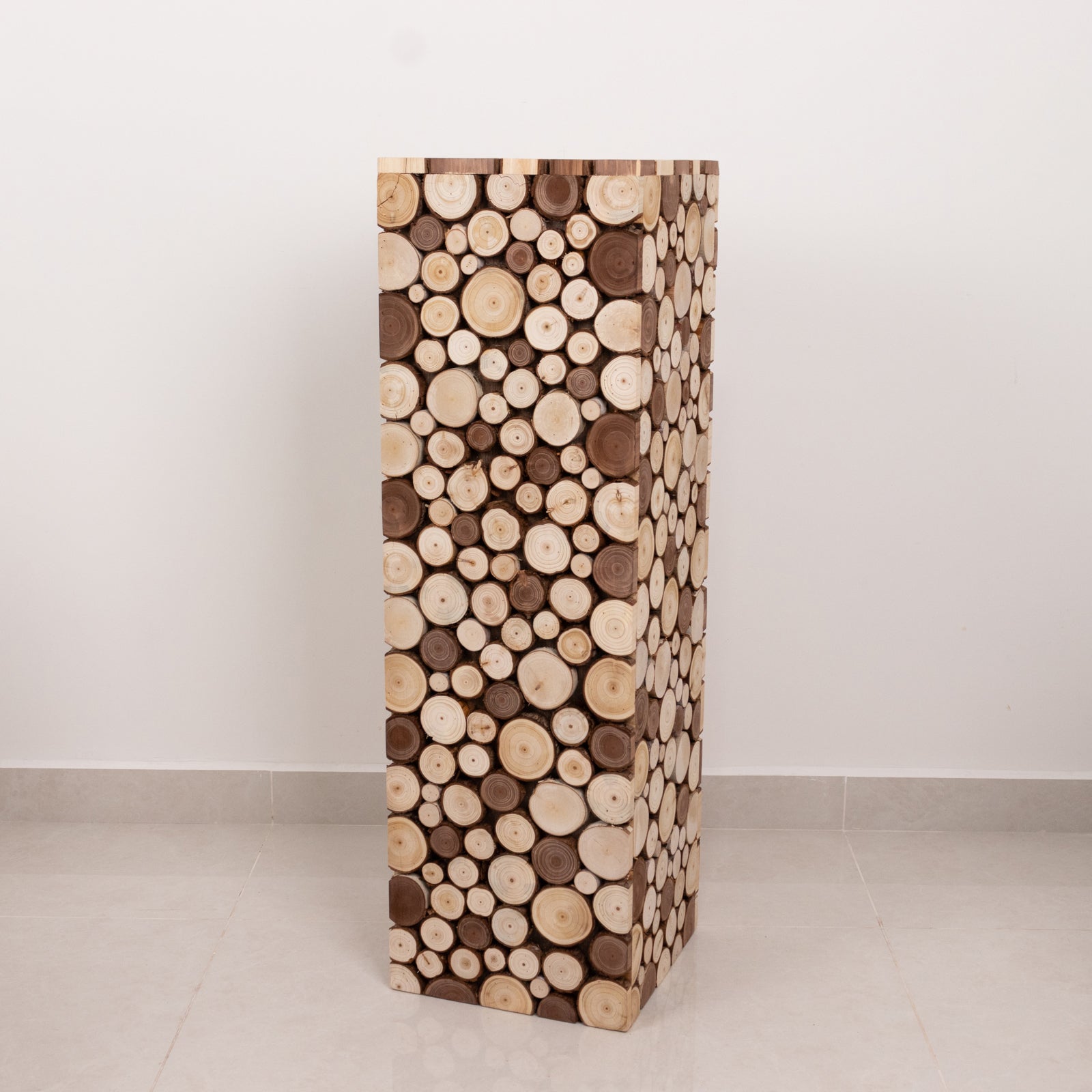 Natural wooden slices pedestal stand for rustic decor.