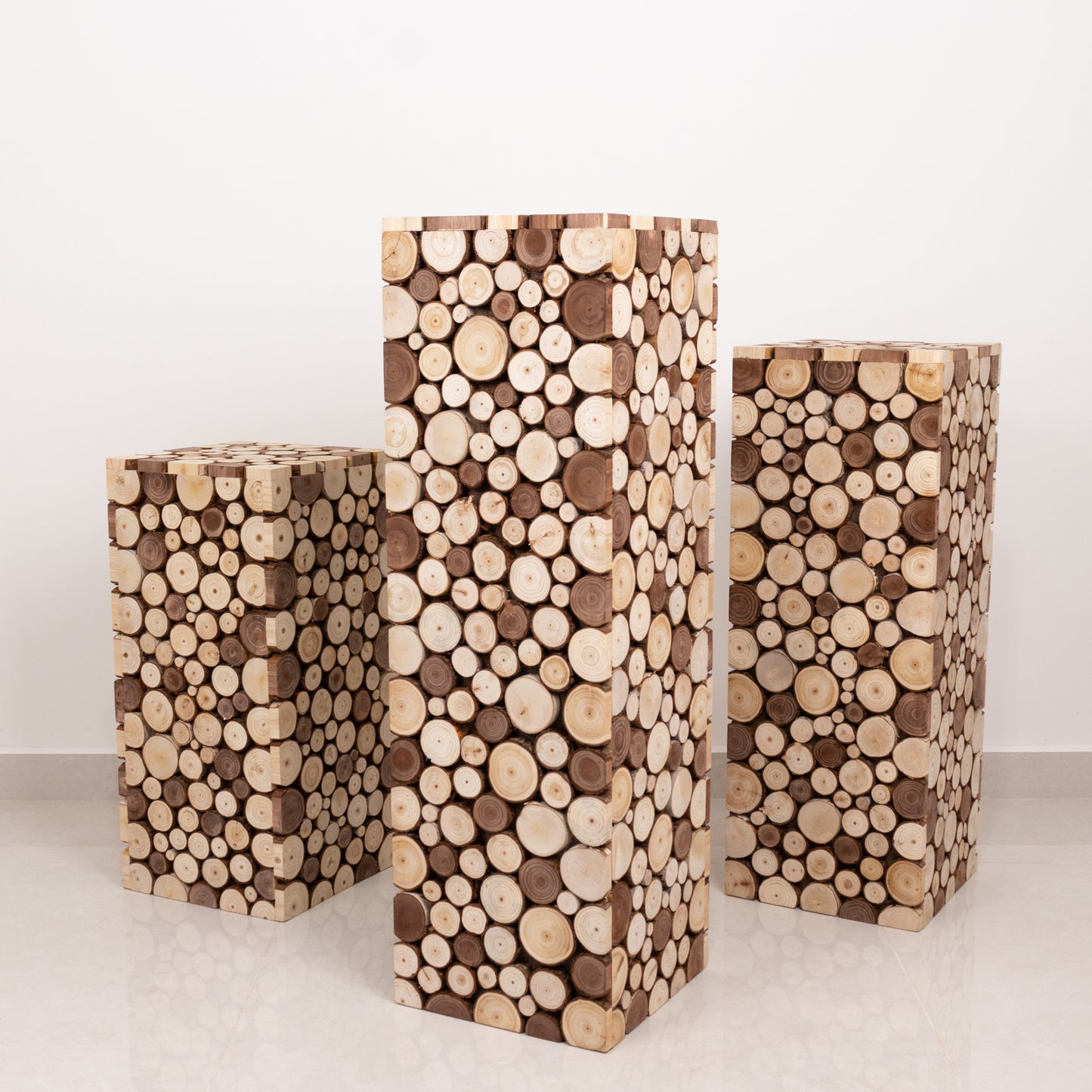 Natural wood pillar stands, rustic farmhouse decor for plants or displays.