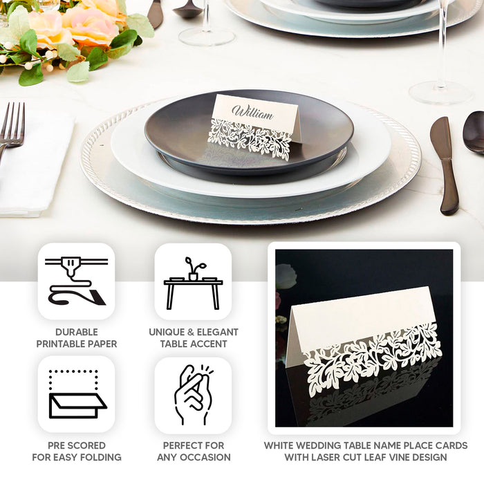 White wedding table number cards with laser cut leaf vine design.