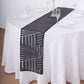 Black diamond glitz sequin table runner on a white tablecloth.