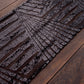 Black diamond glitz sequin table runner on a wooden surface.