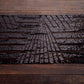 Black diamond glitz sequin table runner on a wooden surface.