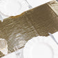 Shiny black and gold foil table runner on a dining table setting.
