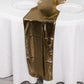 Shiny black gold foil table runner on a white tablecloth.