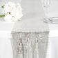 Silver mirror foil table runner on a white table setting.