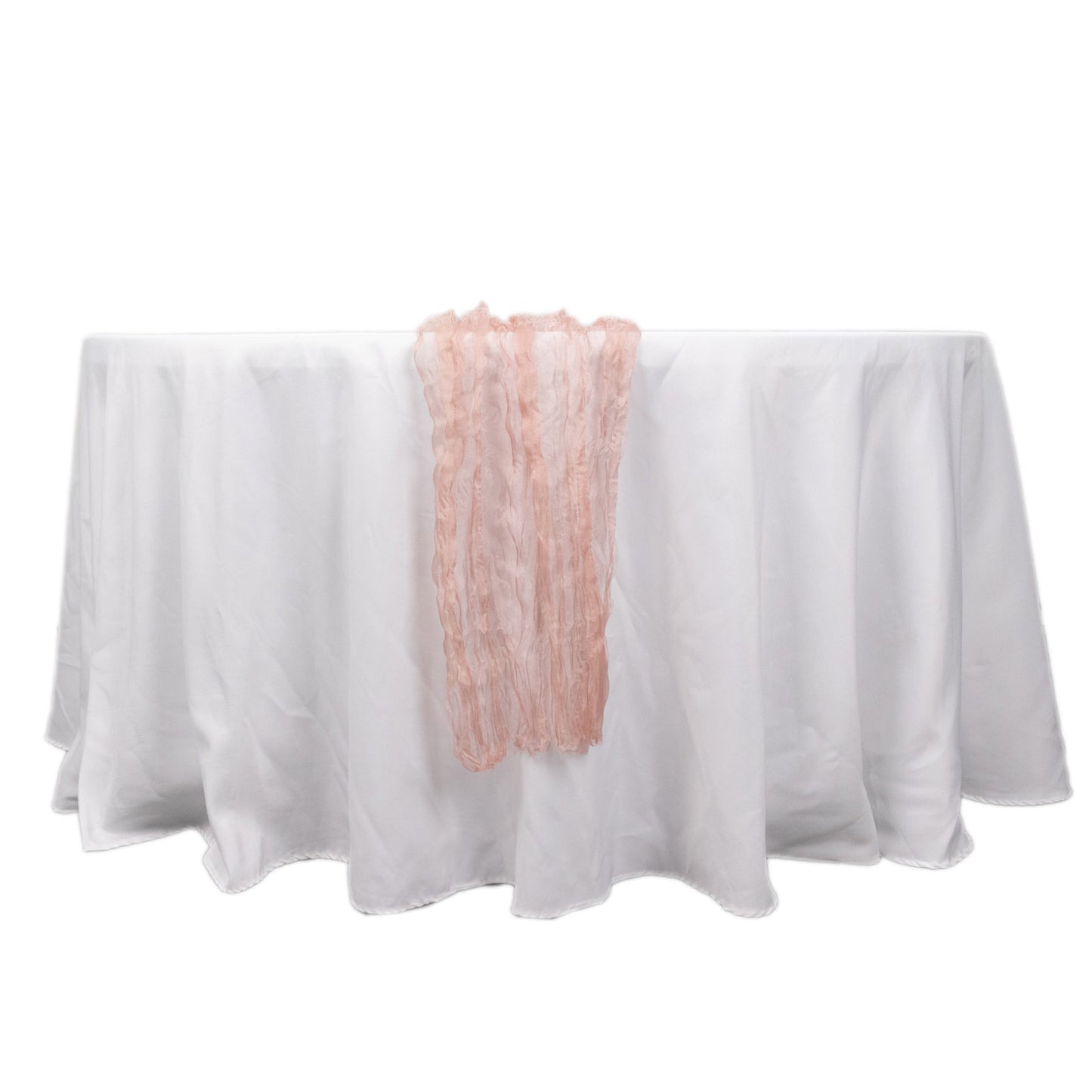 Dusty rose sheer crinkled organza table runner on a white table.