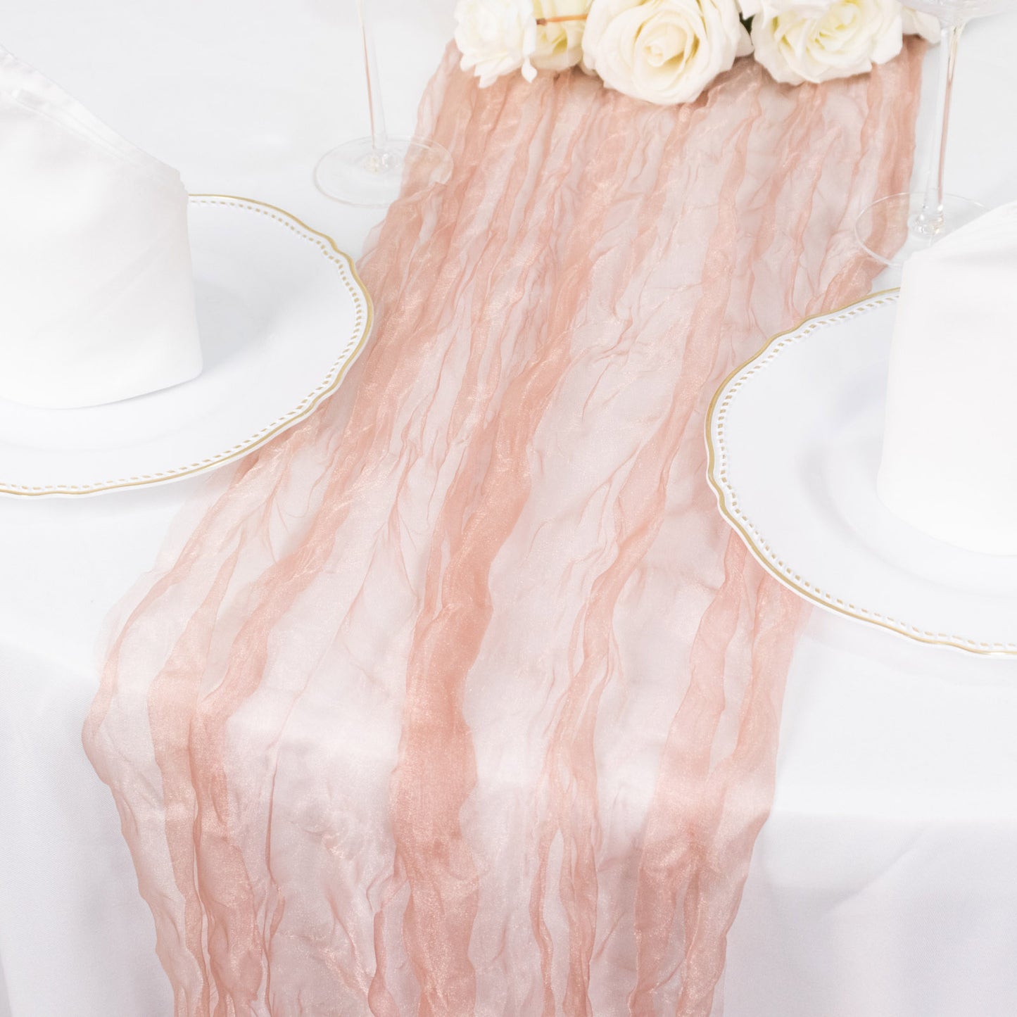 9ft dusty rose sheer crinkled organza table runner on a white table.