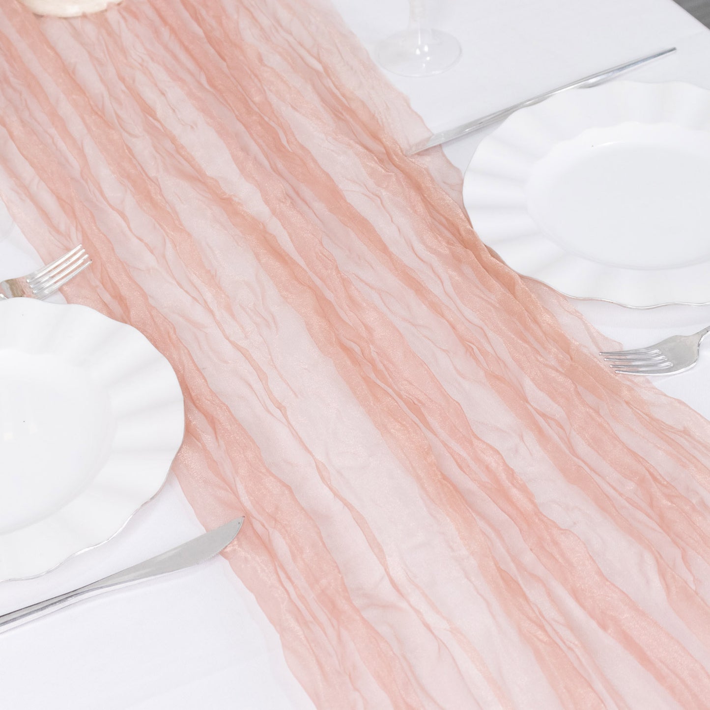 9ft Dusty Rose Sheer Crinkled Organza Table Runner on a white table.