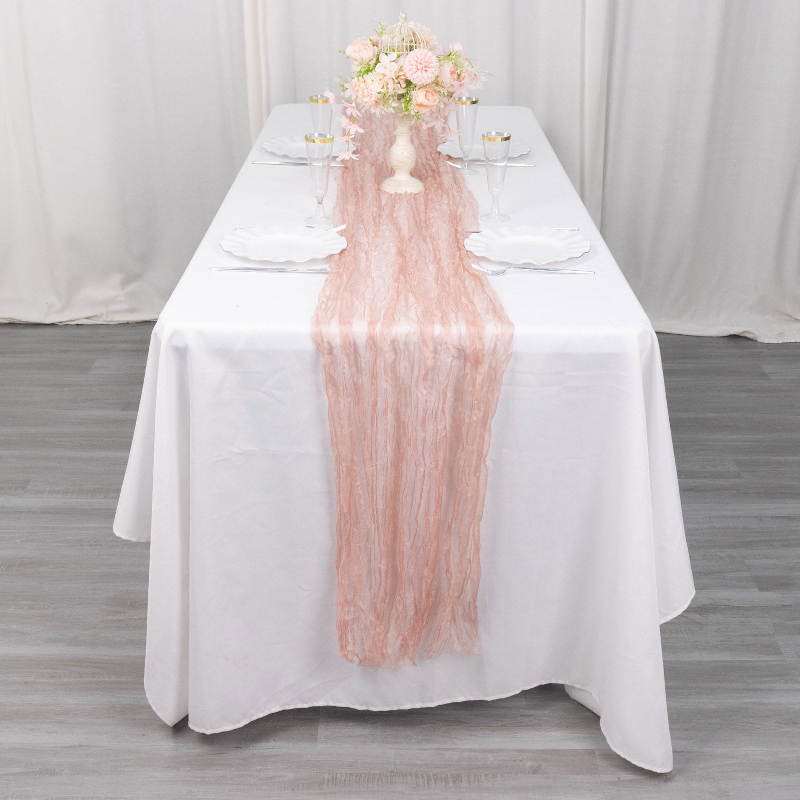 9ft dusty rose sheer crinkled organza table runner on a white table.