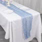 9ft Dusty Blue Sheer Crinkled Organza Table Runner on a white table.