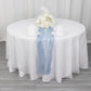 9ft dusty blue sheer crinkled organza table runner on a white table.