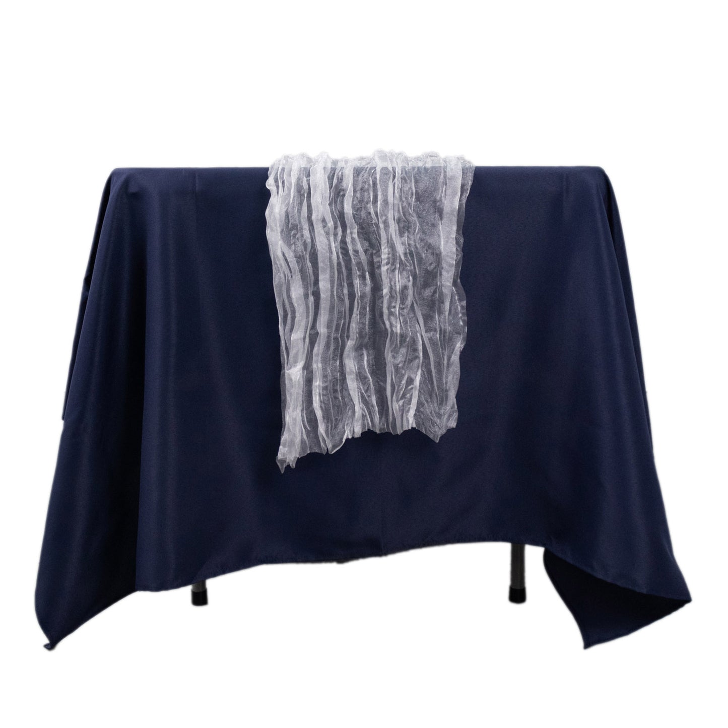 White sheer crinkled organza table runner on a navy blue table.