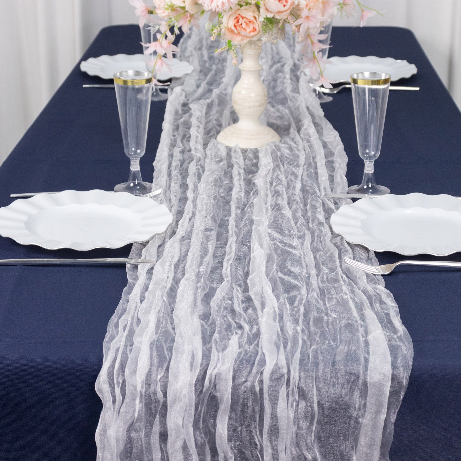 9ft white sheer crinkled organza table runner on a navy blue table.