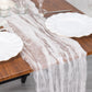 9ft white sheer crinkled organza table runner on a wooden table.