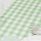 14"x108" white sage green checkered table runner on a dining table.