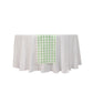 14"x108" White Sage Green Gingham Table Runner on a white table.