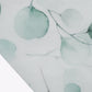 White table runner with green eucalyptus leaves print for dining decor.