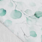 White table runner with green eucalyptus leaves print.