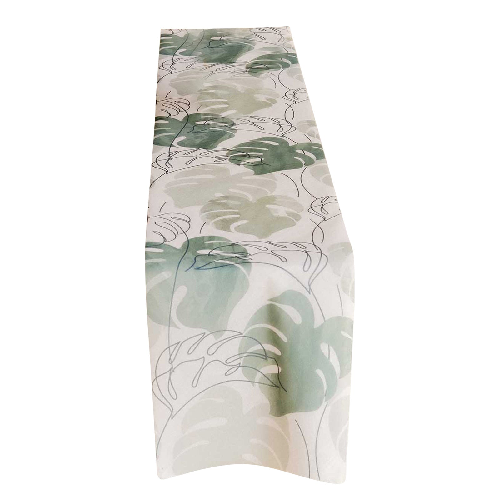 White table runner with green monstera palm leaves print.