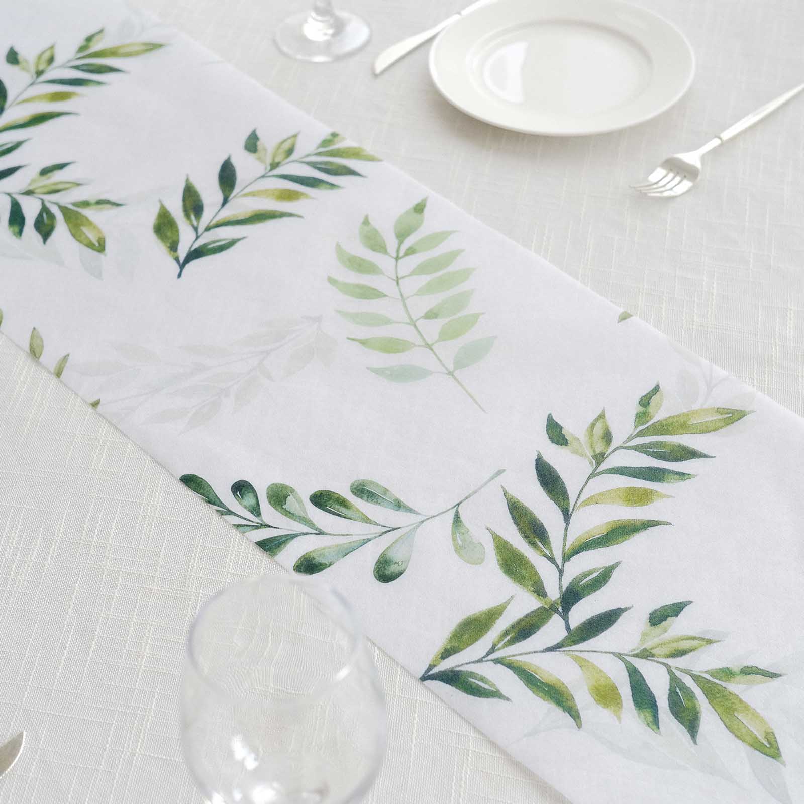 White disposable table runner with green olive leaves print for stylish dining decor.
