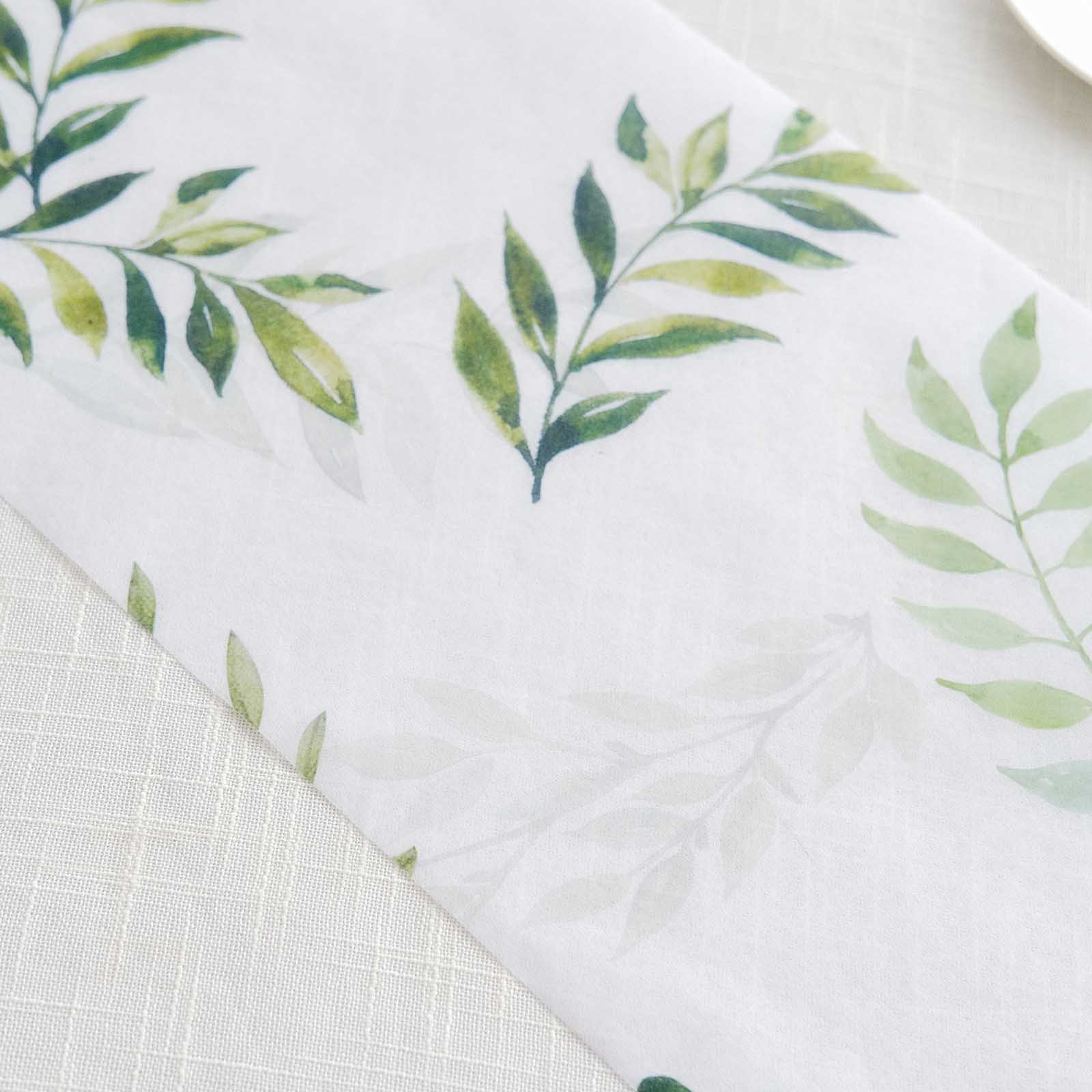 White table runner with green olive leaves print for stylish dining decor.