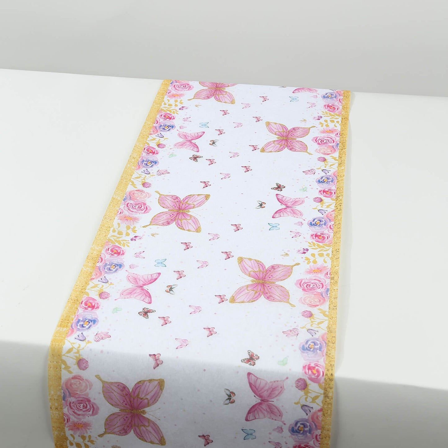 White table runner with pink butterflies for spring summer dining decor.