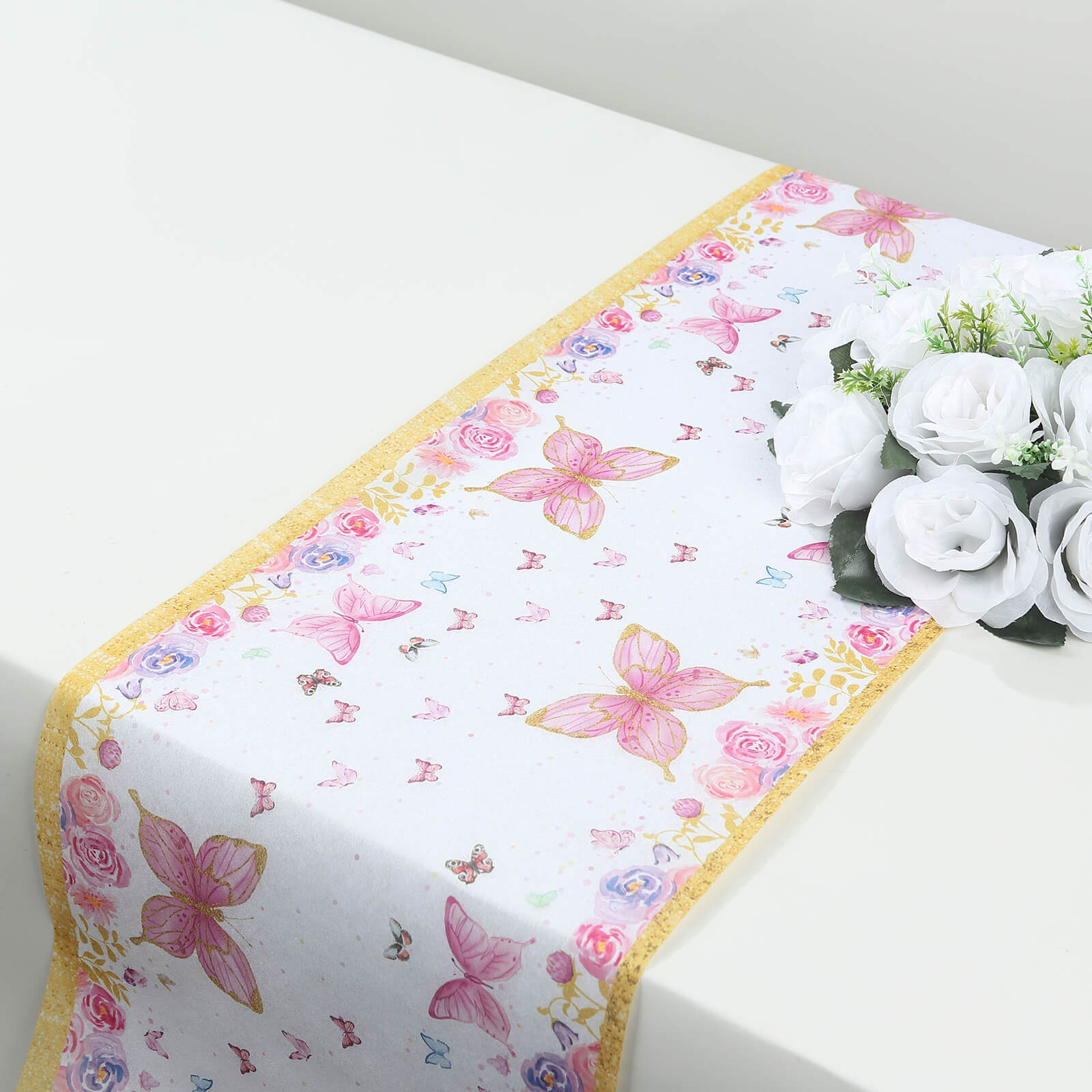 White table runner with pink butterflies for spring summer dining decor.