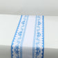 White table runner with blue ornate floral prints, stylish kitchen decor.