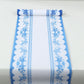 White disposable table runner with blue ornate floral prints.