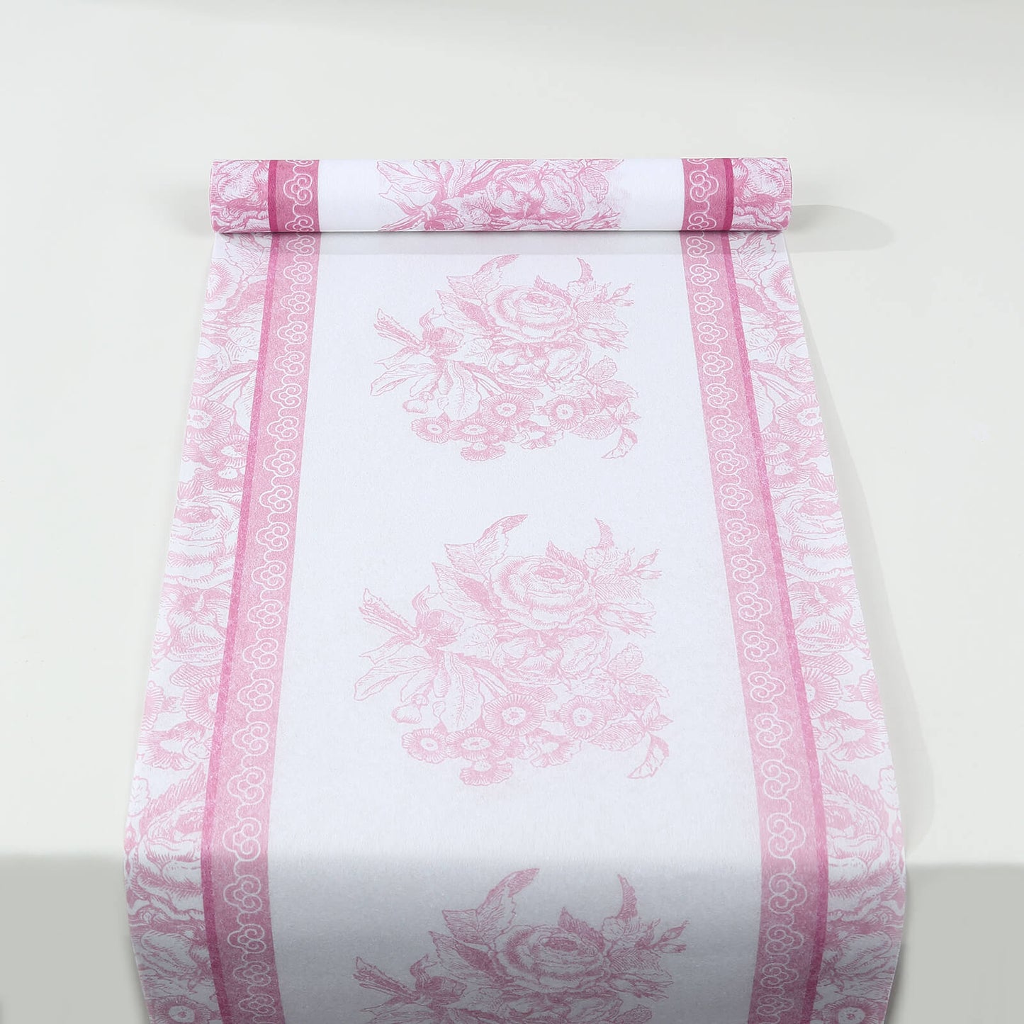 White table runner with pink floral pattern, stylish for dining decor.