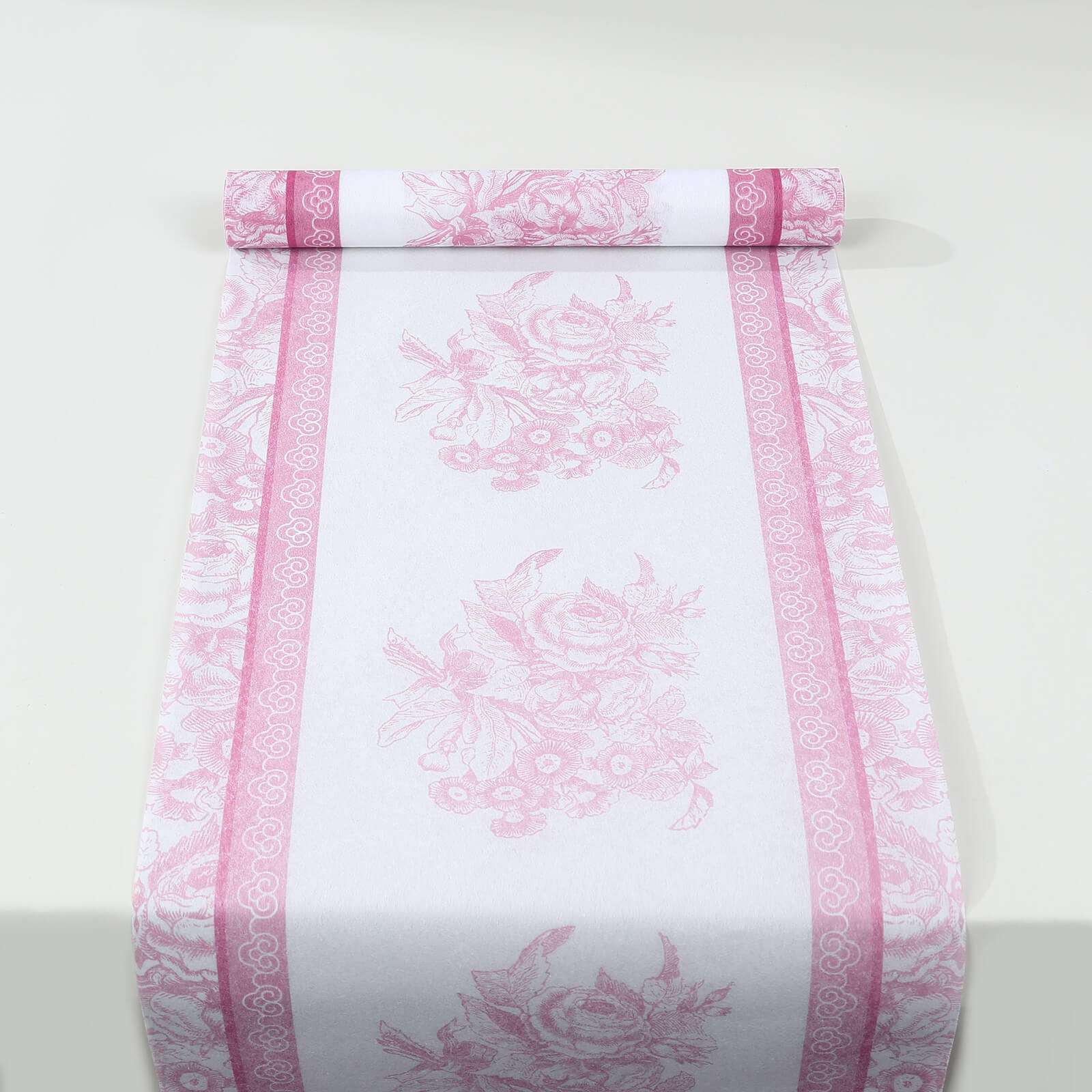 White table runner with pink floral pattern, stylish for dining decor.