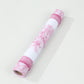 White with pink floral disposable table runner rolled up.