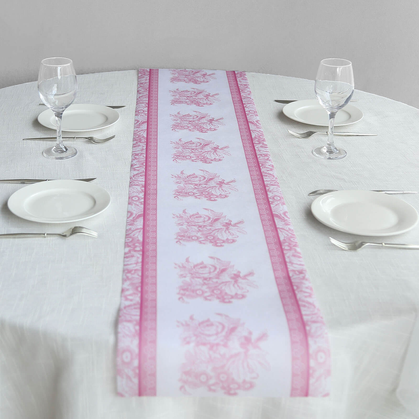 White and pink floral disposable table runner on a dining table.