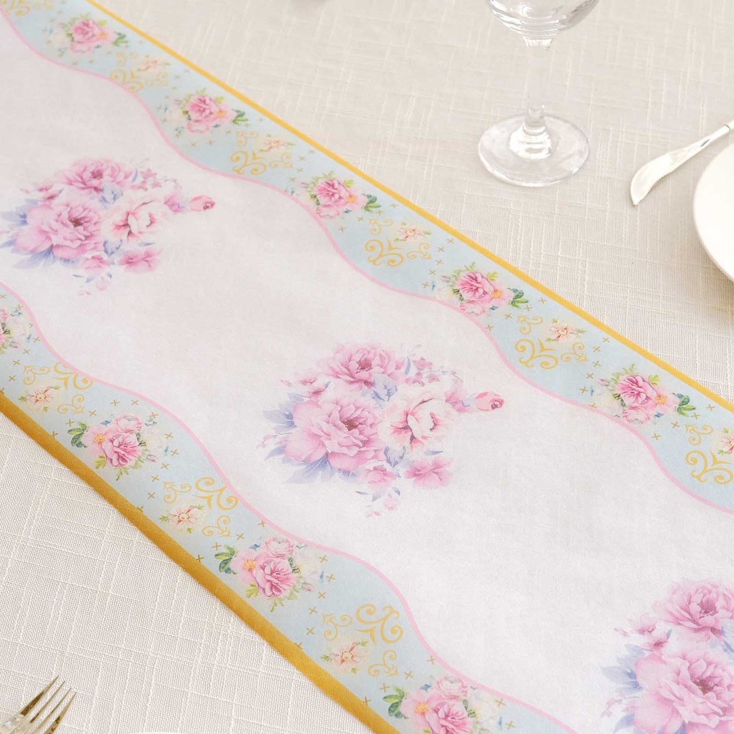 White table runner with pink peony floral print for spring summer dining decor.