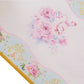 White table runner with pink peony floral print for spring and summer dining decor.