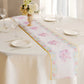 White with pink peony floral print disposable table runner on a dining table.