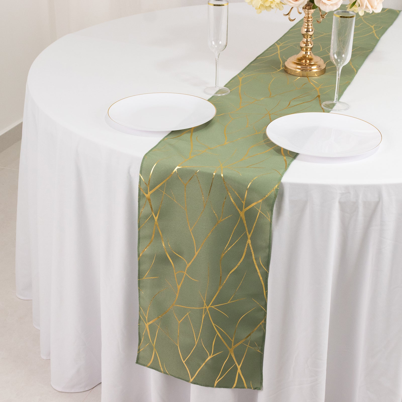 Dusty sage green table runner with gold foil tree branch pattern.