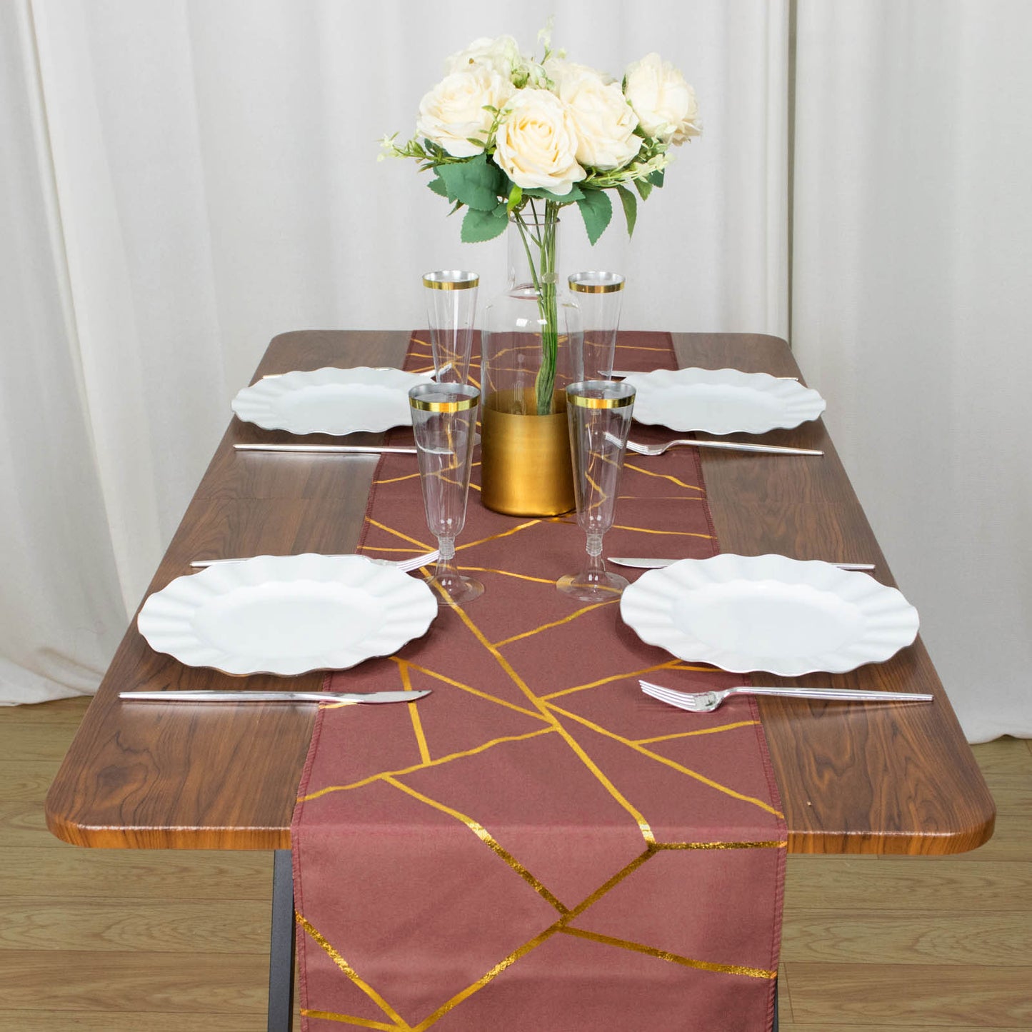Cinnamon rose table runner with gold foil geometric pattern on a dining table.