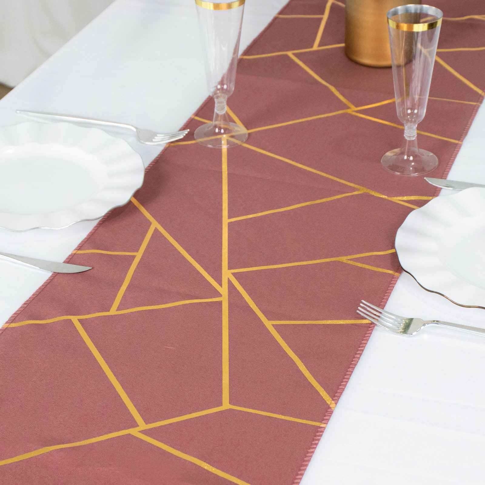 Cinnamon rose table runner with gold foil geometric pattern.
