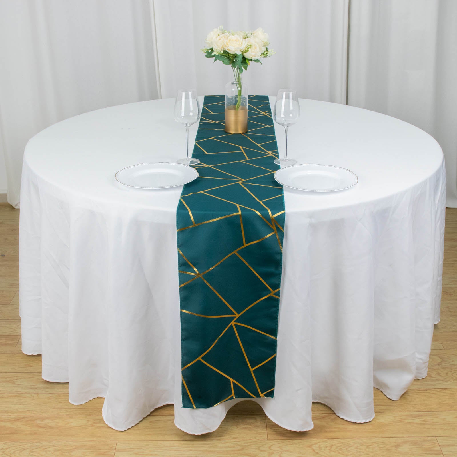 Peacock teal geometric pattern table runner on a round white table.