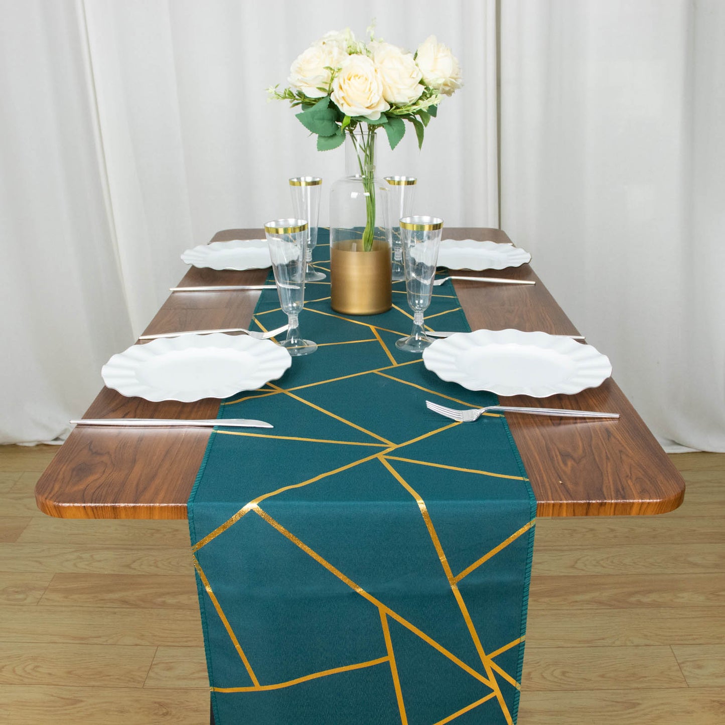 Peacock teal table runner with gold foil geometric pattern on a wooden table.