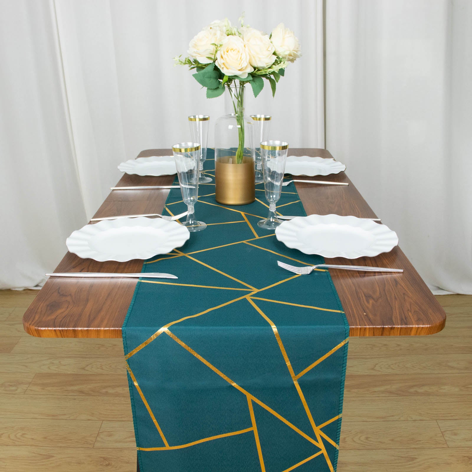Peacock teal table runner with gold foil geometric pattern on a wooden table.